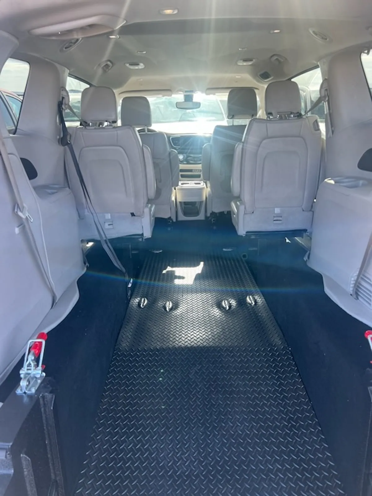 Inside a Naeli wheelchair minivan, showing the lowered floor and securement tracks