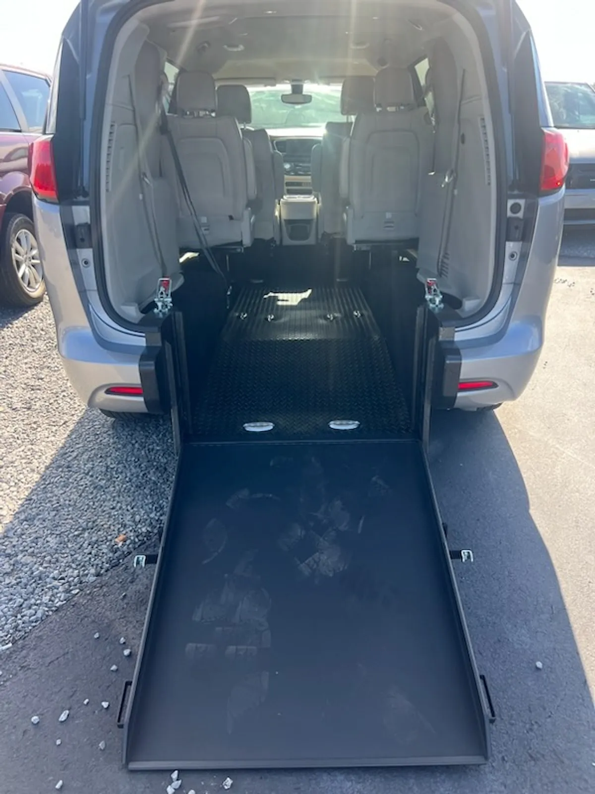 A Naeli wheelchair-accessible minivan with its rear ramp lowered
